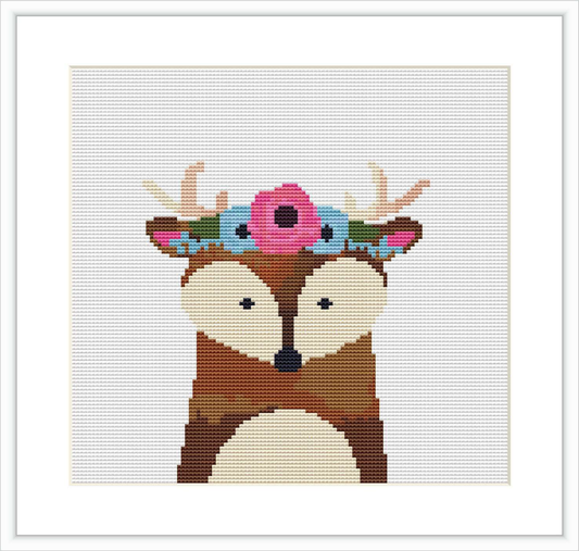 The image depicts a cross stitch pattern of a deer with a floral wreath on its antlers, centered on a white canvas.