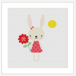 The image displays a cute cartoon bunny in a pink dress with a floral pattern, holding a red flower. A yellow sun is placed in the upper right corner against a plain white background.