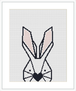 The image shows a stylized, geometric cross stitch pattern of a bunny with the design predominantly using black, white, and shades of grey, with pink accents on the ears. It is displayed against a greyish-white background.