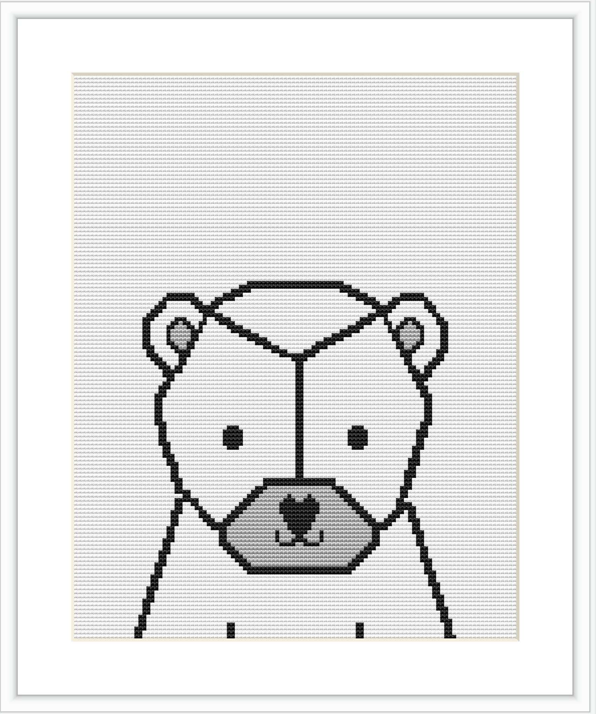 A cross stitch pattern depicting a stylized geometric polar bear centered within a rectangluar frame.