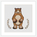 The image depicts a cross stitch pattern of a stylized bear with a rounded body standing upright. The bear is centered on the canvas, flanked by two symmetrical stalks of leaves which create a sense of balance. The design is rendered on a white evenweave fabric.