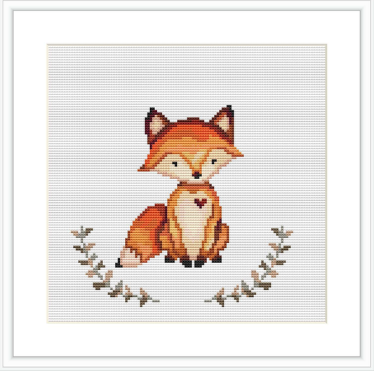 The image shows a cross stitch design of a stylized fox sitting calmly. The fox is centered on the fabric with a simple framework of leafy branches at the bottom. The design is embroidered on an even-weave fabric that appears framed for display.