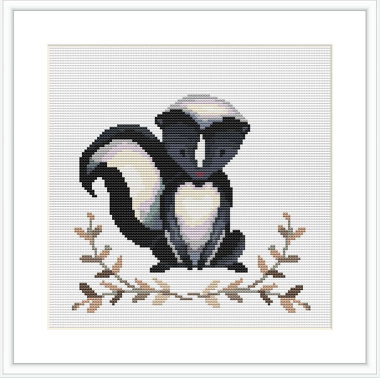 The image depicts a cross stitch pattern showing a skunk in a seated position with its tail raised, set against a simple background with leafy branches at the base.