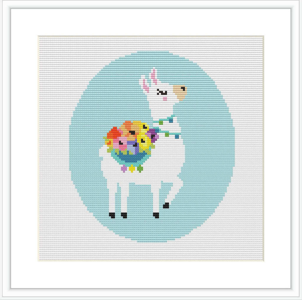The image is a digital mock-up of a cross stitch pattern showing a stylized white llama with closed eyes, rosy cheeks, and a bouquet of multicolored flowers around its neck. The llama is centered against a blue circular background surrounded by a grid of white cross stitches.