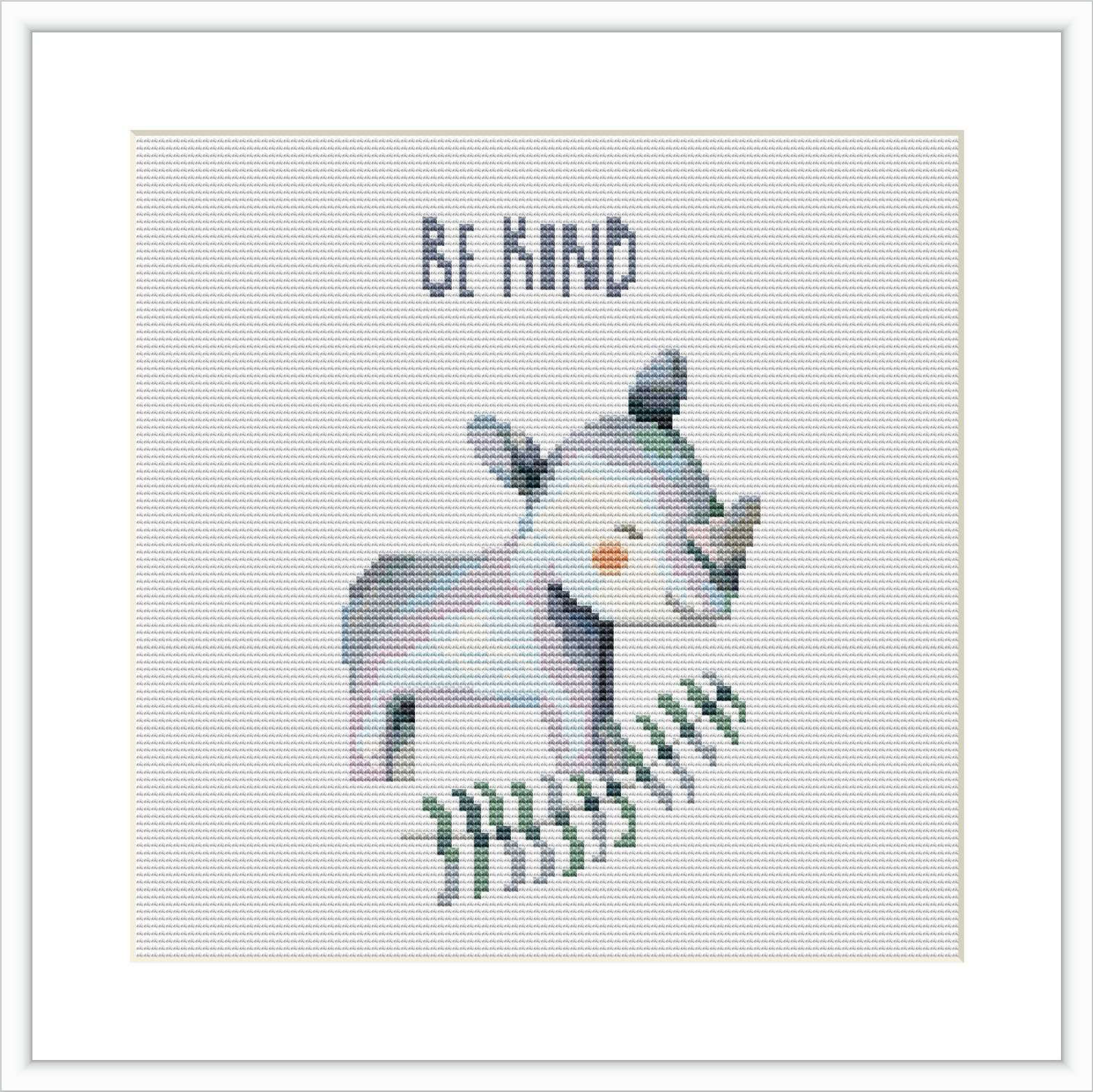 The image displays a cross stitch embroidery design framed in white. Centrally, there is a cartoon-style rhinoceros standing in profile with a friendly expression, over a text that reads 'Be KIND'. The animal is depicted in shades of blue and gray with green details at the bottom to suggest grass.