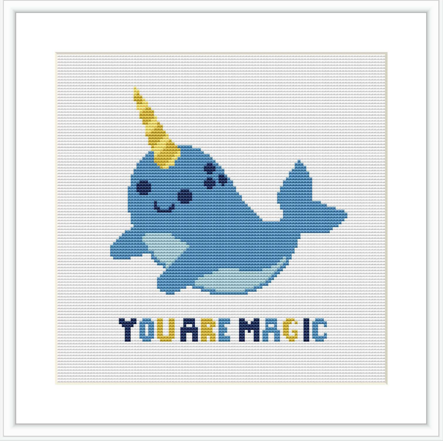 The image features a cross stitch pattern design of a cheerful blue narwhal with a golden horn, accompanied by the inspirational phrase 'YOU ARE MAGIC' in blue lettering, all centered against a white background within a square frame.