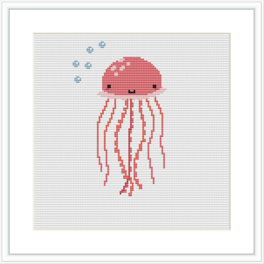 The image shows a stylized cross stitch pattern of a coral pink jellyfish with dangling tentacles and a pair of cute, simple eyes. Above the jellyfish, there are small blue bubbles. All elements are against a plain white background.