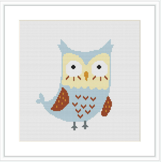 The image shows a cross stitch pattern of a stylized owl with a mix of blue, brown, and cream colors. The owl is front-facing with a patterned body and is positioned centrally against a plain white background, framed by a simple square border.