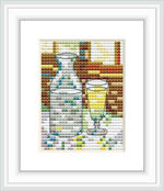 The cross-stitch pattern depicts a carafe and a glass on a table, mimicking the style of Van Gogh's painting 'Still Life with Absinthe'.