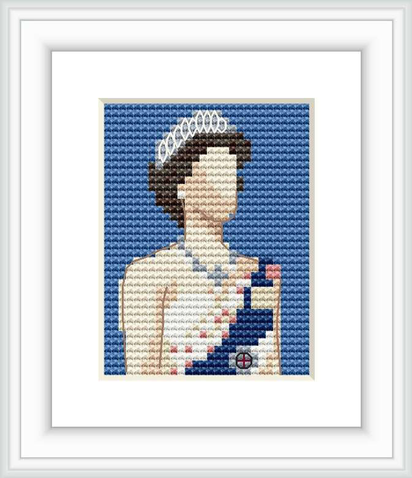 The image displays a framed cross stitch pattern of a stylized portrait resembling a queen with a crown. The visible stitched area is set against a blue background with other colors forming the image centrally placed within a white mount and a darker frame.