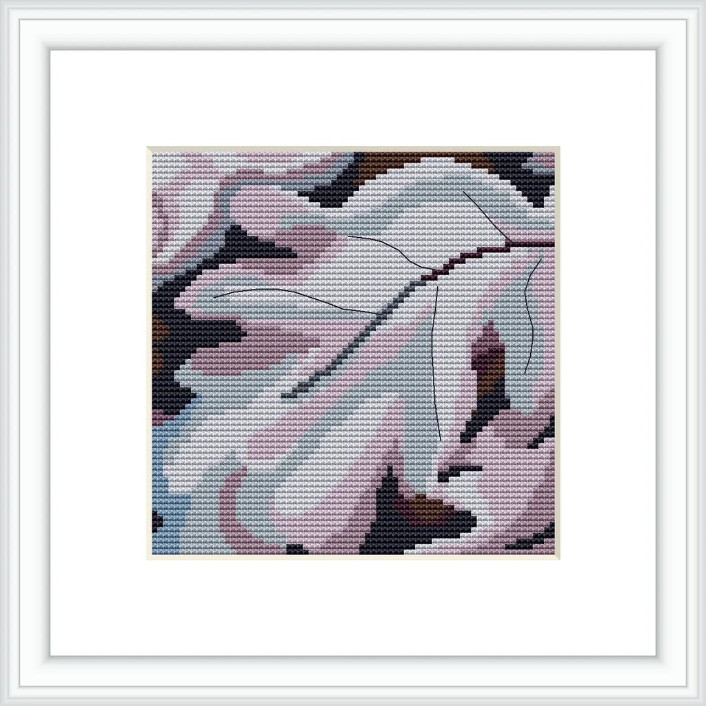 A framed cross stitch pattern that resembles the abstract shapes of leaves with a predominant use of purple hues and a modernist style, placed against a white background.