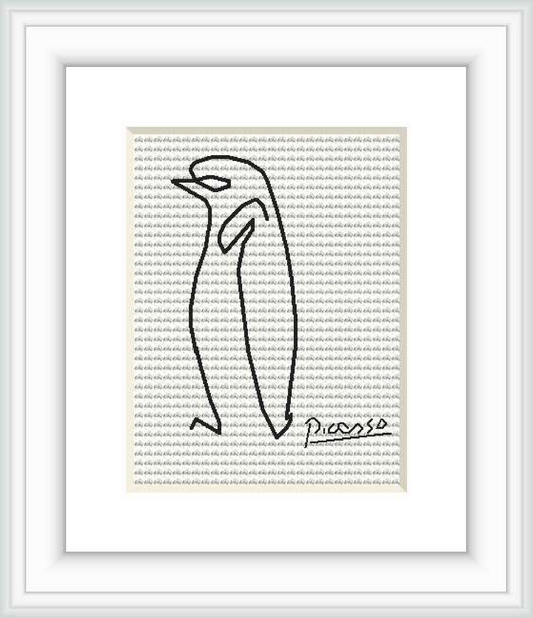 The image displays a framed cross stitch pattern depicting an abstract penguin figure with a signature resembling that of Pablo Picasso. The stitch work is black on a white aida cloth, surrounded by a white mat and a simple frame.