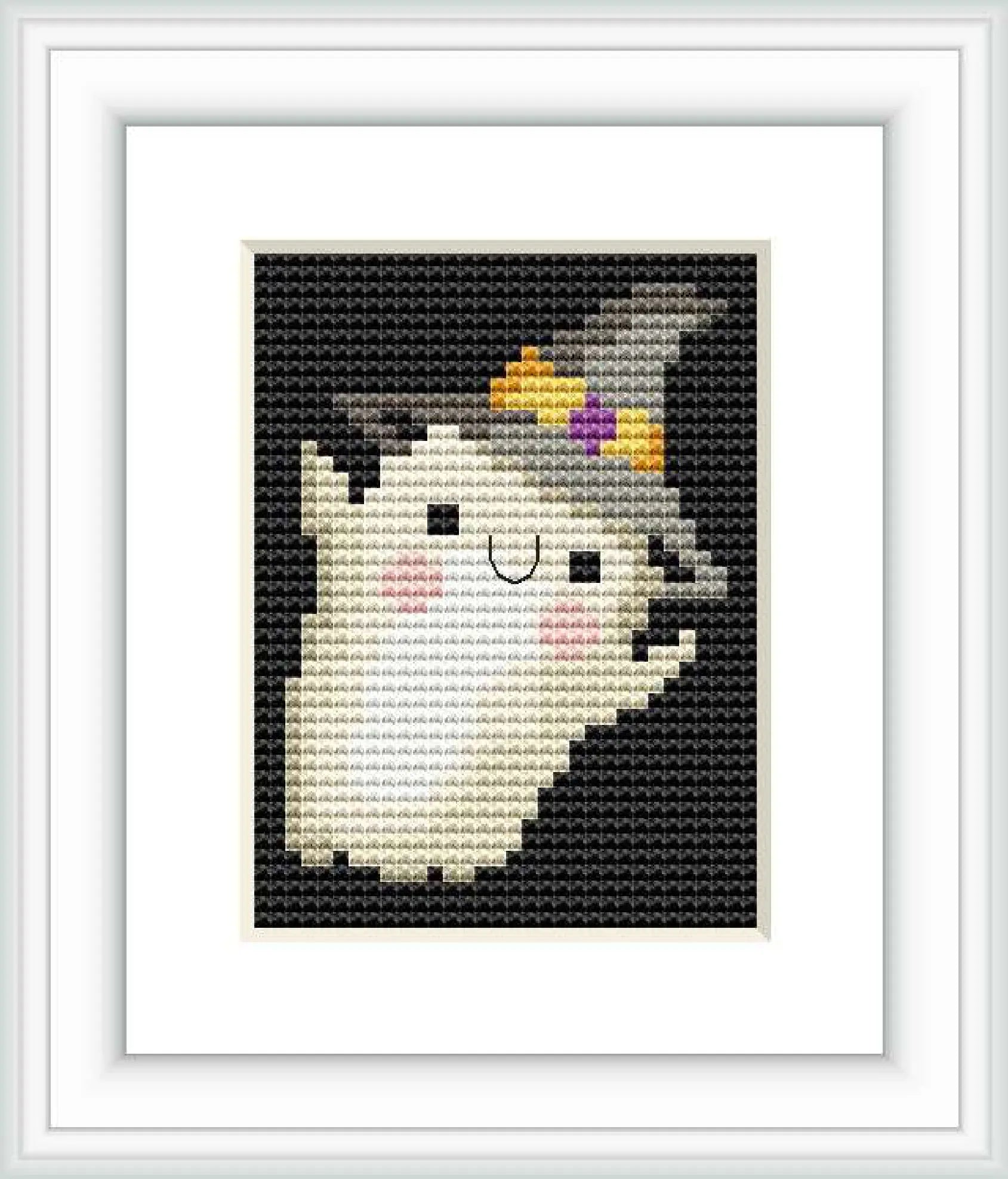 The image shows a framed cross stitch embroidery of a stylized ghost figure with a small crown on its head. The embroidery is made of small, precise stitches with varying shades to create depth and detail.