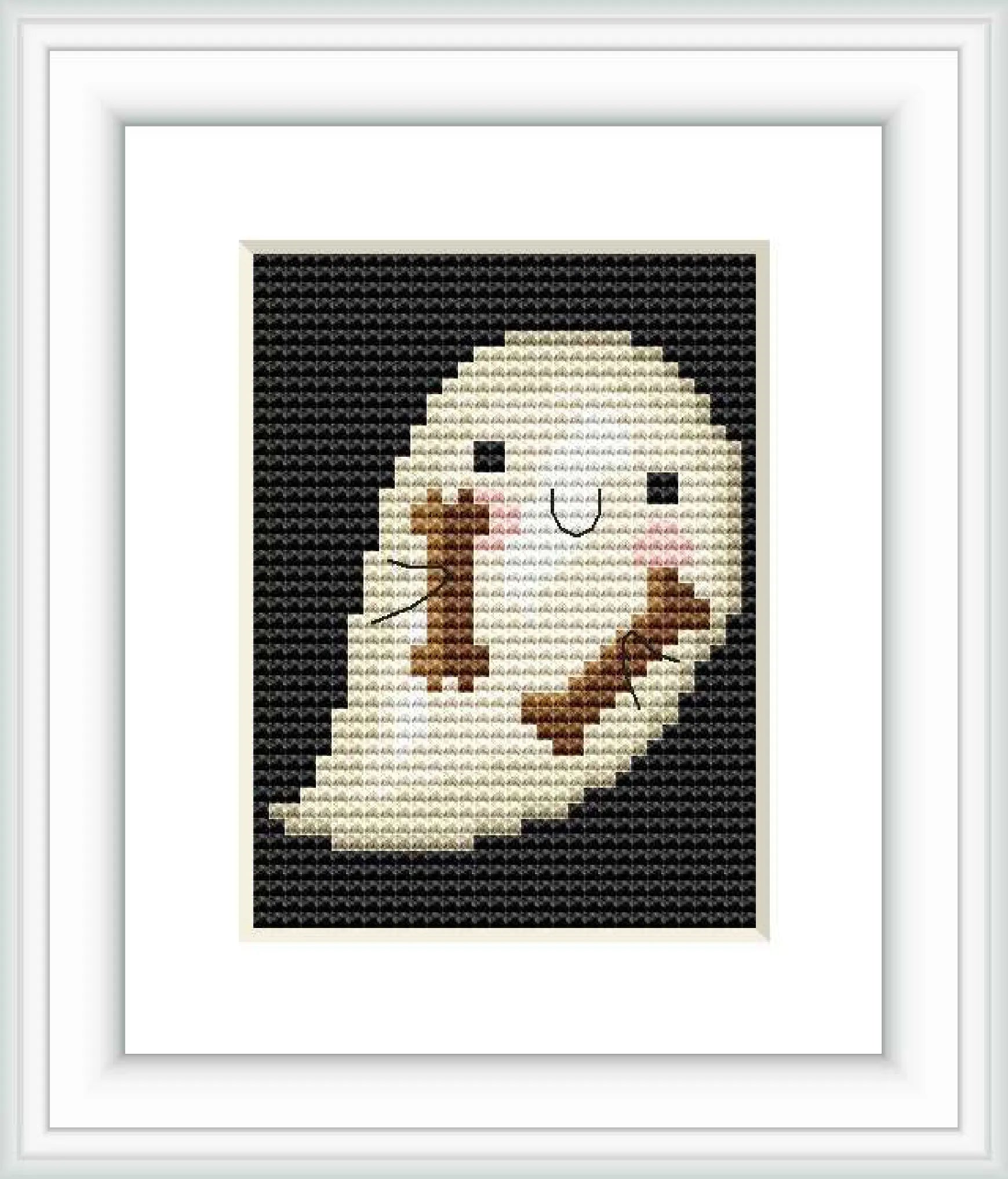 The image shows a framed cross stitch embroidery of a cartoonish ghost. The ghost is depicted in a simplified form with a smiling face and appears against a dark background.