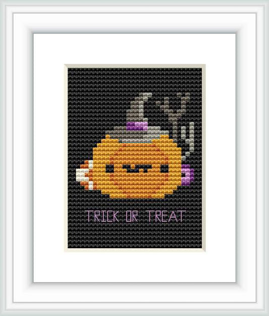 The image displays a cross stitch pattern with a stylized pumpkin ghost wearing a witch's hat against a black background, with the caption 'TRICK OR TREAT' at the bottom.