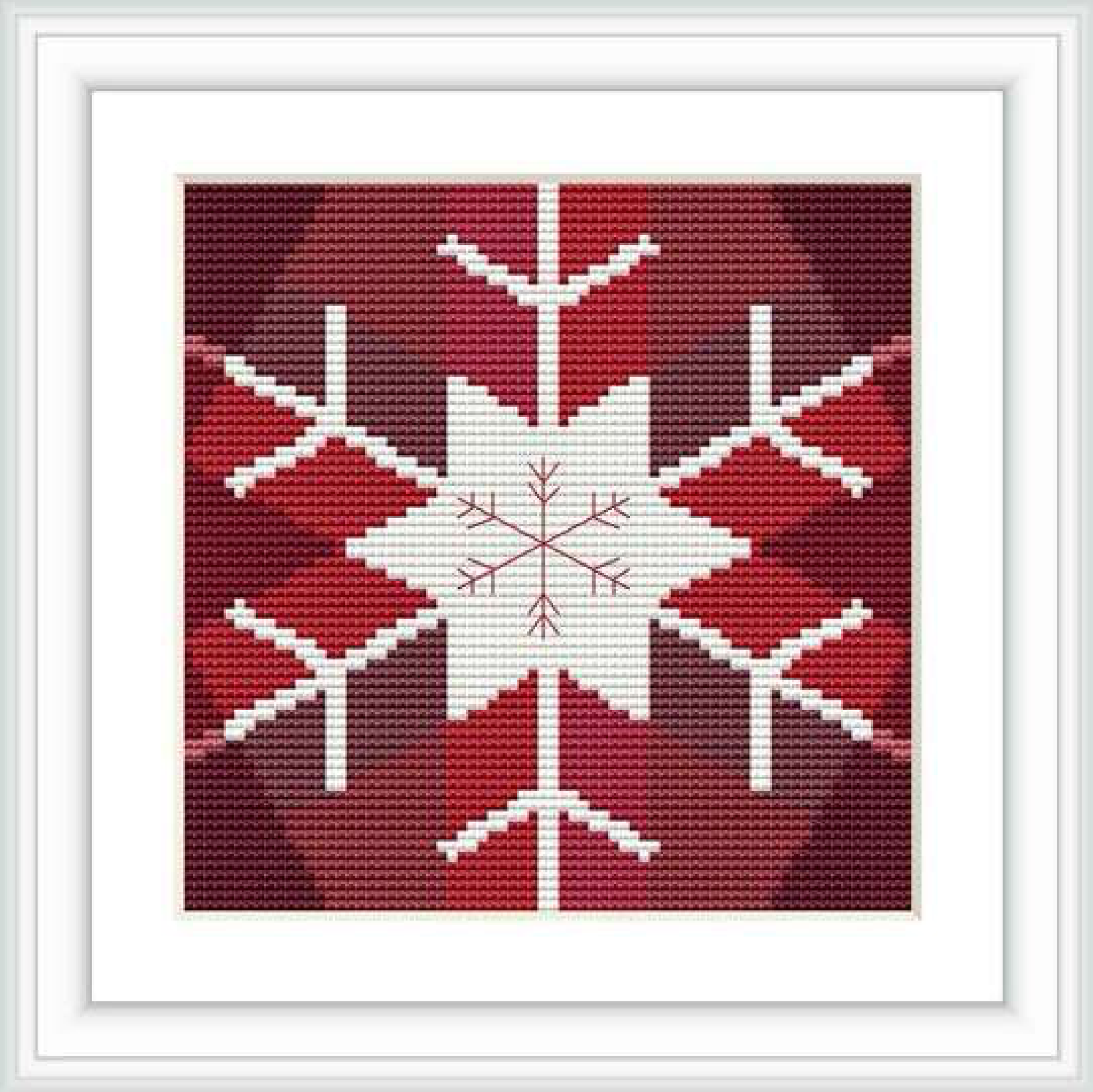 The image shows a cross stitch pattern featuring a central white snowflake on a red background, bordered by a thin white frame.