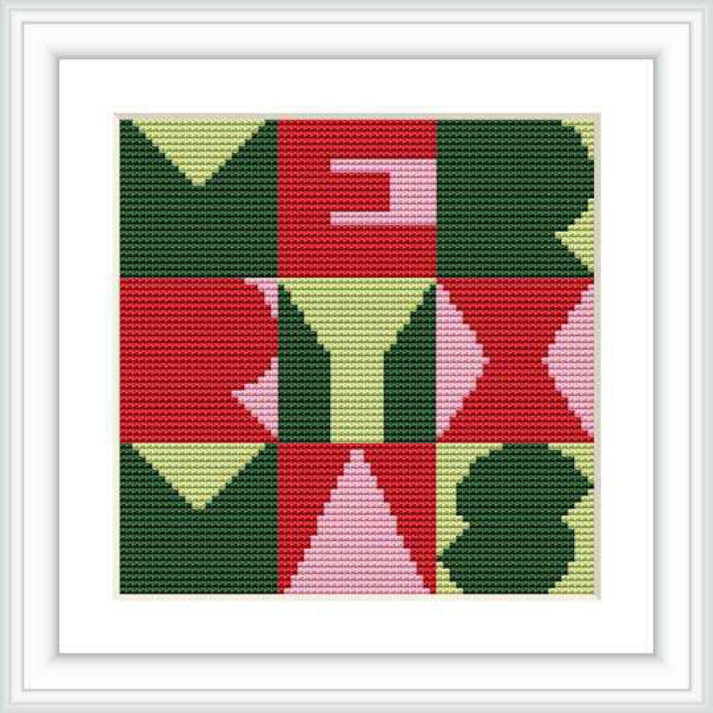 The image displays a cross stitch pattern framed in a simple white border. The pattern itself is divided into a grid of geometric shapes that resemble Christmas themed elements in a symmetrical arrangement. The background is solid.