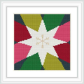 The image showcases a framed cross stitch pattern featuring a large multi-pointed star in the center with segments of red, green, and yellow, bordered by black. Small festive motifs embellish the star, set against a white background.
