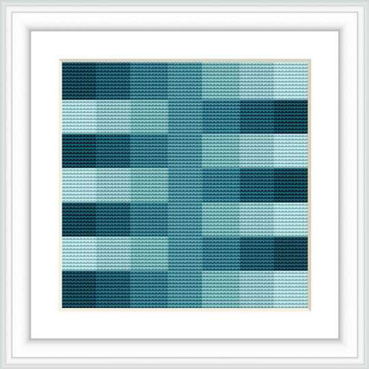 This is a framed image of a cross stitch pattern design. The design features a geometric pattern with varying shades of blue and squares aligned in a grid. The gradients form a pixelated effect.