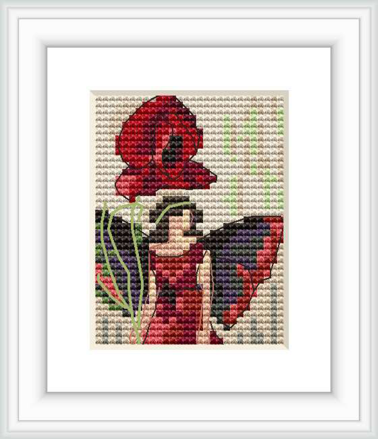 The image depicts a cross stitch pattern of a stylized fairy, resembling the work of Cicely Mary Barker, surrounded by foliage and standing next to a large poppy flower. The fairy and the poppy are central in the frame with a neutral, off-white background to emphasize the colors of the subject.