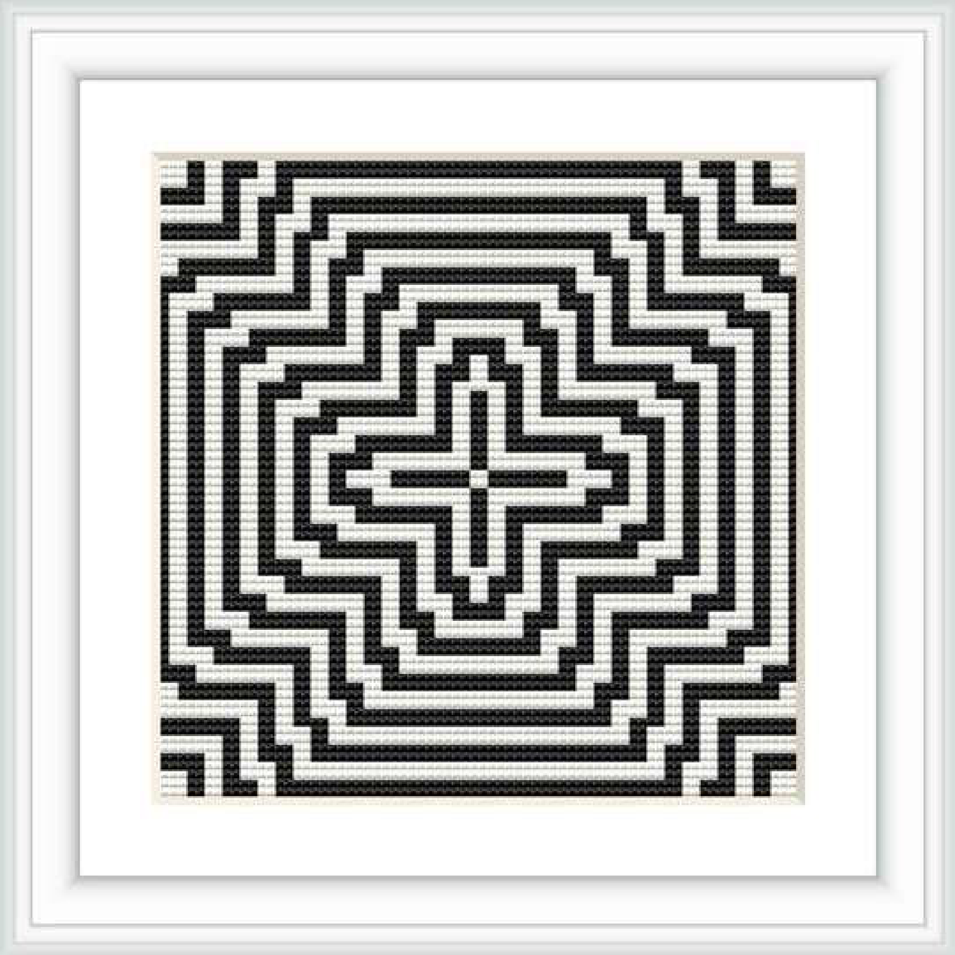 The image shows a cross stitch pattern of geometric design in a square frame, using a monochrome color scheme of black and white.