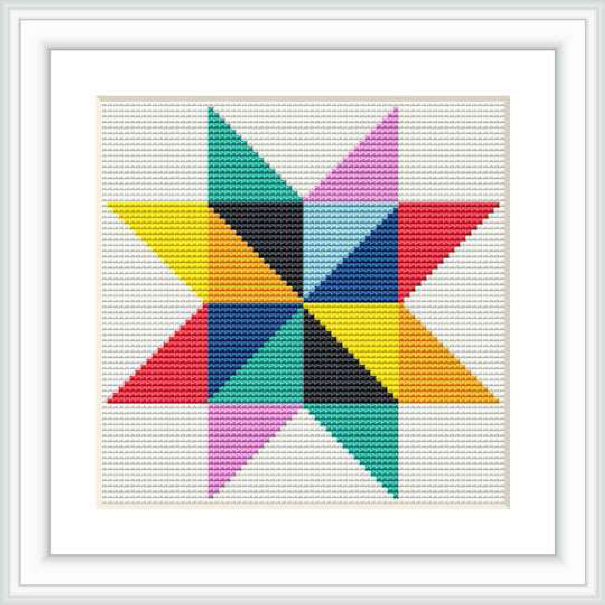 The image shows a framed cross stitch embroidery work portraying a colorful geometric star pattern centered on a white canvas.