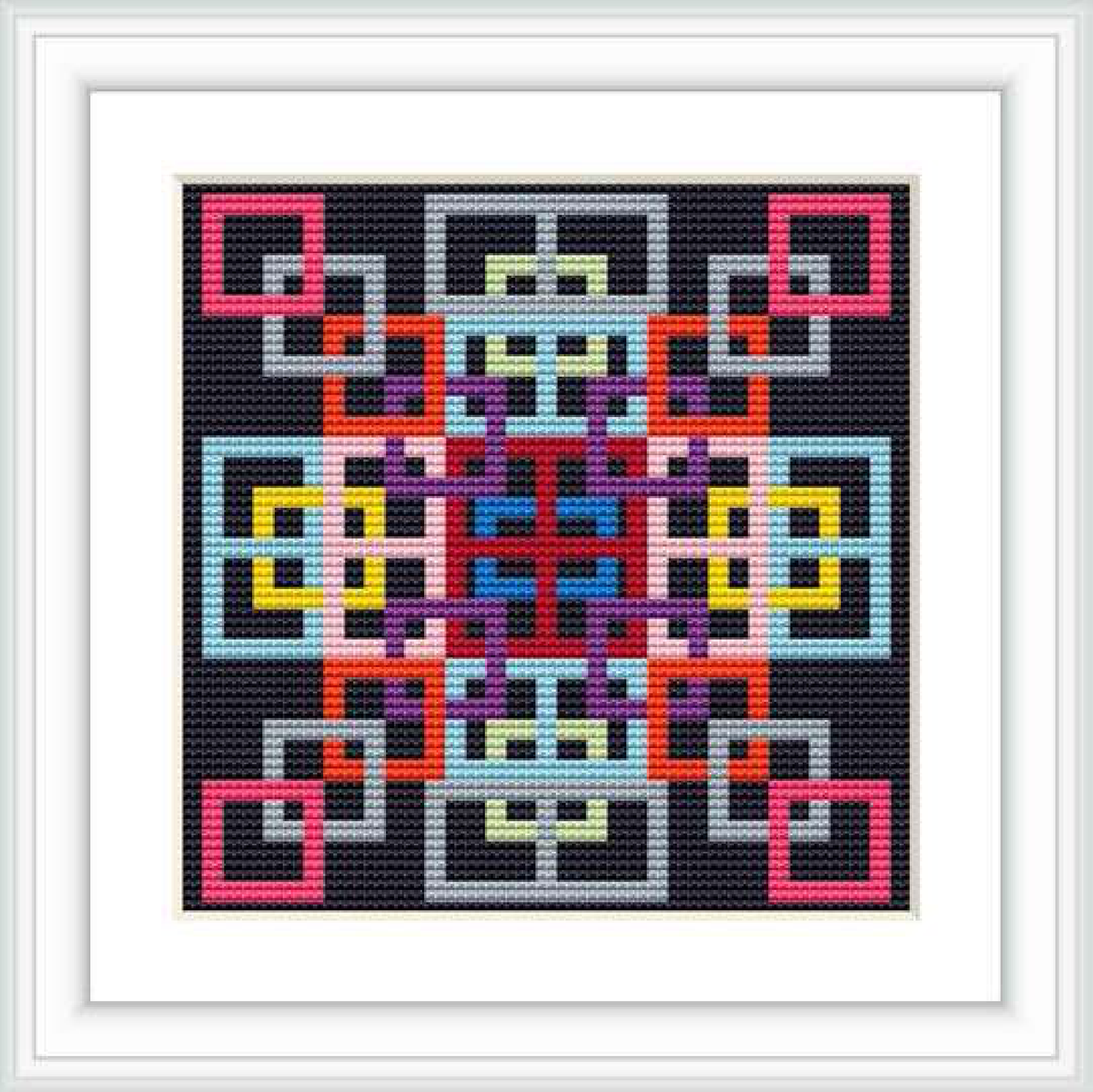 The image displays a framed cross stitch pattern featuring a complex geometric design with multiple colors on a black background.