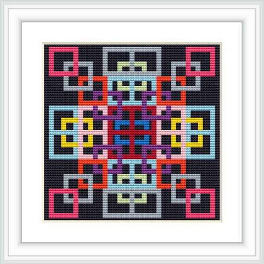 The image displays a framed cross stitch pattern featuring a complex geometric design with multiple colors on a black background.