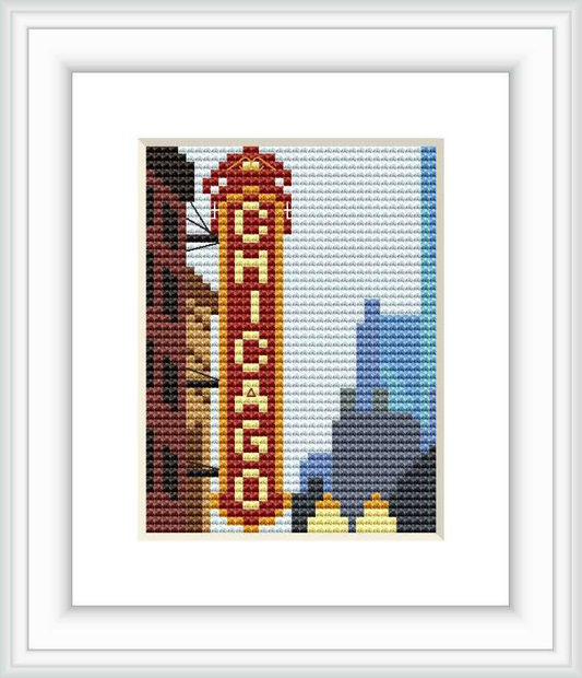 The cross stitch pattern features a miniature representation of the Chicago skyline, including iconic buildings and the word 'CHICAGO' in large red letters down a central building.