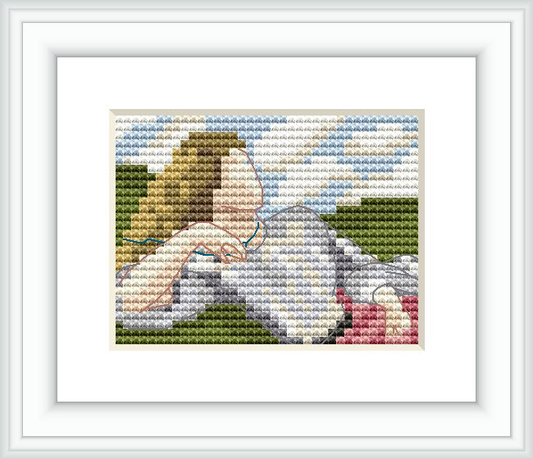 The cross stitch pattern depicts a woman lying in a grassy field with her head resting on her hand—her gaze reflects contemplation. The image captures the delicate textures of her clothes and surroundings.