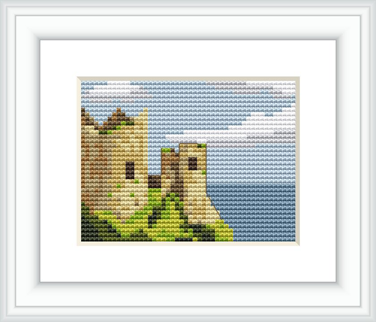 The image displays a cross stitch pattern of an old Irish castle set against a background of blue skies with wisps of clouds. The castle is surrounded by greenery, suggesting a serene rural location.