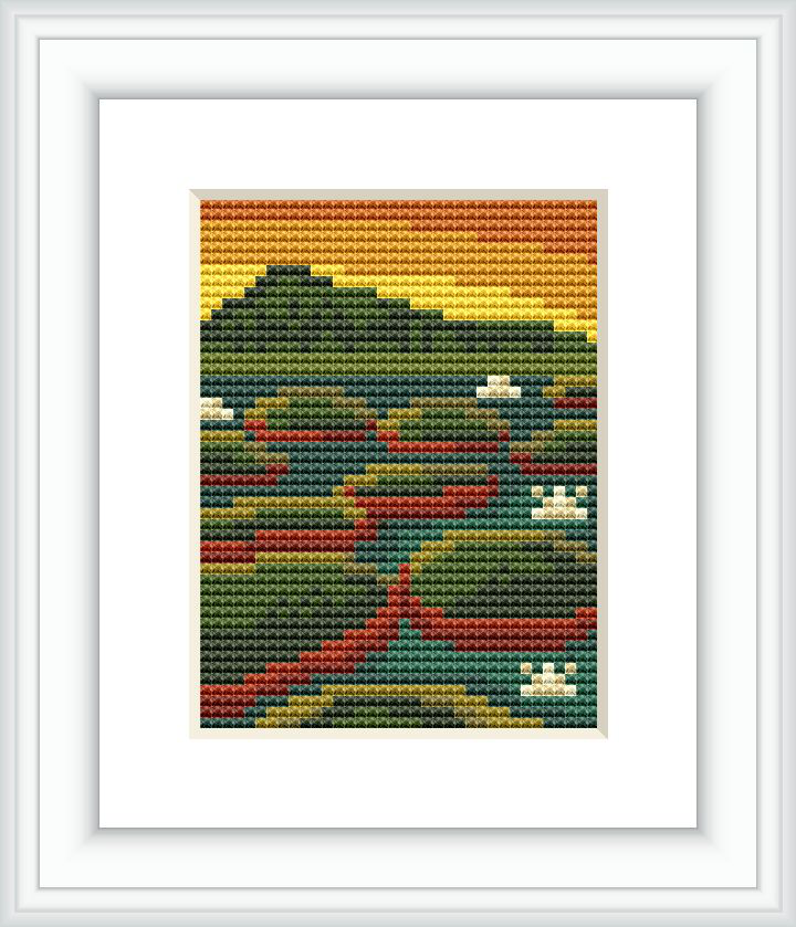 The image depicts a cross stitch pattern framed in white, showcasing a stylized mountain landscape with varying shades of greens, browns, yellows, and hints of red.