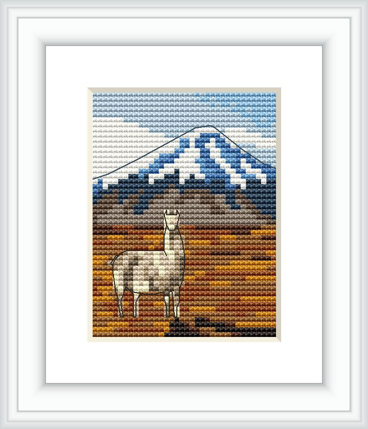 The image displays a framed cross stitch pattern featuring a white llama in the foreground with a textured brown and orange ground. Behind the llama is a large blue and white snow-capped mountain filling the upper background, against a sky transitioning from white to blue.