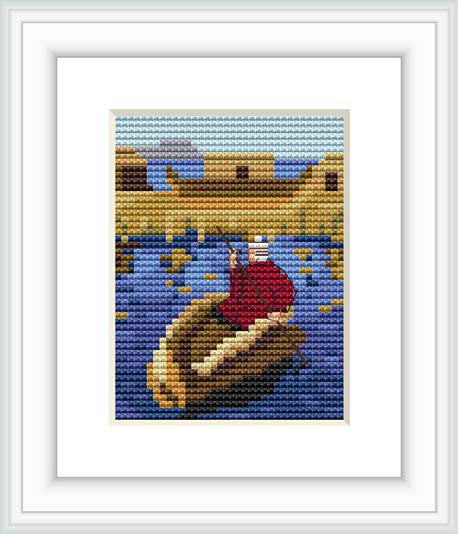 The cross stitch pattern features a traditional Bolivian reed boat floating on a calm lake with a golden-brown backdrop that represents either a sunset sky or a distant shore.