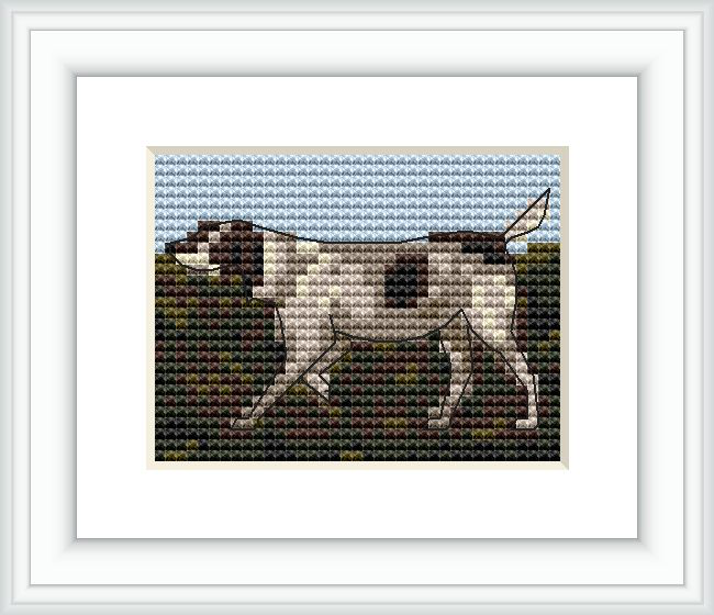 The image shows a framed cross stitch pattern depicting a hunting dog in profile. The dog is centered, against a blue sky backdrop and above a field-like texture, within a white mount and a simple dark frame.