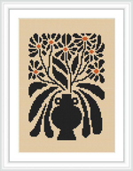 The image shows a framed cross-stitch pattern depicting a bouquet of flowers in a vase, predominantly in black with cream background and orange-tinted accents.