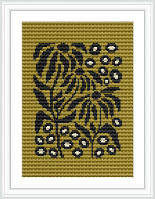 The image displays a framed cross stitch pattern featuring a floral design with black threads on a khaki-colored canvas, encased in a white square frame against a white background.
