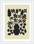 The image features a framed cross stitch pattern of a stylized black floral design with orange and black flowers, set against a cream background.