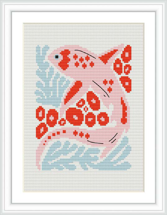 The image shows a framed cross stitch pattern depicting a stylized pink fish surrounded by blue waves and bubble motifs. The fish is centered, and the background is composed of aquamarine hues with white accents. The pattern is presented within a square frame.