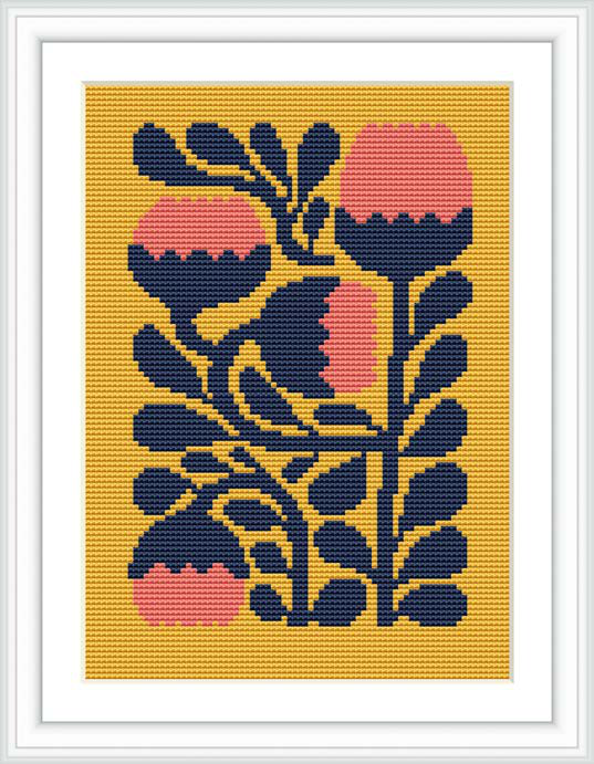 The image showcases a cross stitch pattern framed within a white border. It features stylized floral motifs consisting of bulbous flowers and elongated leaves set against a mustard yellow background. The primary colors are navy blue and coral, creating a harmonious contrast.