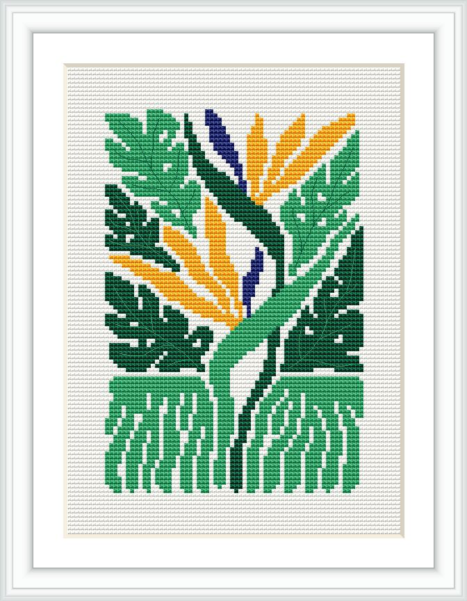 The image depicts a framed cross stitch piece with a tropical motif. The pattern features stylized green leaves and stems with spots of yellow and blue that suggest flowers and buds. It is displayed against a white background and within a white frame, emphasizing its colorful design.
