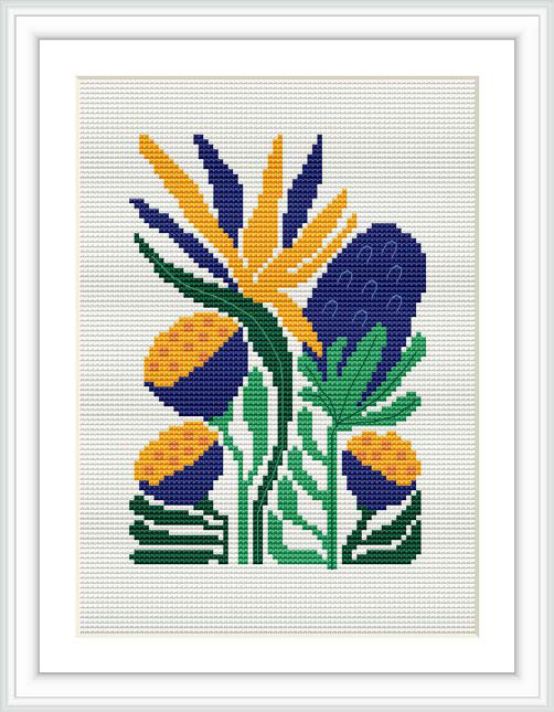 A framed cross stitch pattern depicting tropical foliage with broad leaves and elongated shapes in vivid yellow, green, purple, and blue colors on a white background.