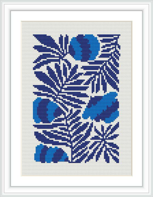 The image shows a framed cross stitch pattern of stylized blue flowers and leaves on a white canvas, executed in various shades of blue and white thread.