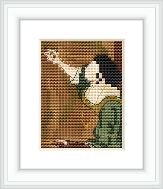 The image represents a small, framed cross stitch pattern depicting a segment of a self-portrait by Artemisia Gentileschi, showcasing the hand and face of the figure with an emphasis on the eye.