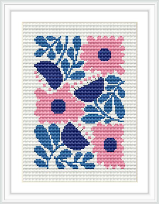 The image depicts a cross stitch pattern framed within a white border. The design illustrates pink and blue flowers with navy and light blue leaves against a white background.