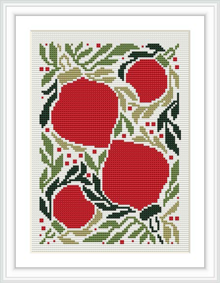 The image shows a framed cross stitch design of a Christmas-themed pattern featuring red Christmas lights entwined with greenery and small beads or lights, on a white fabric background.