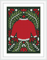 This cross stitch pattern depicts a red Christmas sweater design, framed by a border of green with white holly leaves, red berries, white snowflakes, and a bow at the top.