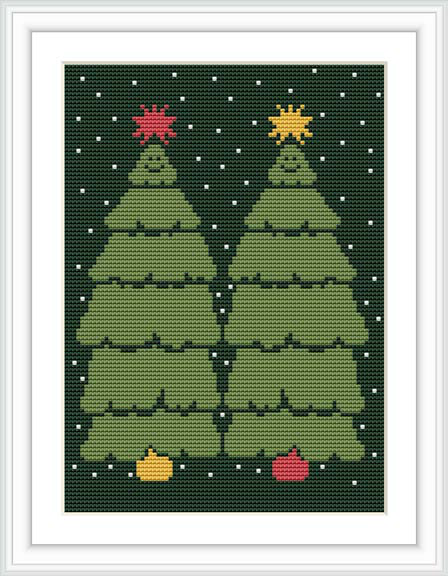 The image displays a framed cross stitch pattern showing two green Christmas trees with star-shaped toppers and colorful ornaments, set against a dark blue background with white snowflakes.