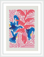 The image presents a cross stitch pattern framed and displayed as a finished piece. It depicts a stylized bird in shades of blue with yellow and red accents, perched on flowering branches against a pink and white background.