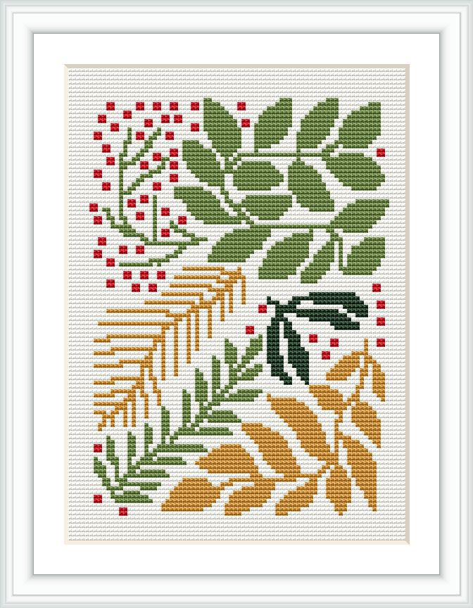 The image showcases a framed cross stitch pattern featuring stylized floral motifs in a traditional Christmas color palette, arranged asymmetrically on a white aida cloth. The pattern includes various types of leaves and berries, depicted using red, green, gold, and brown threads.